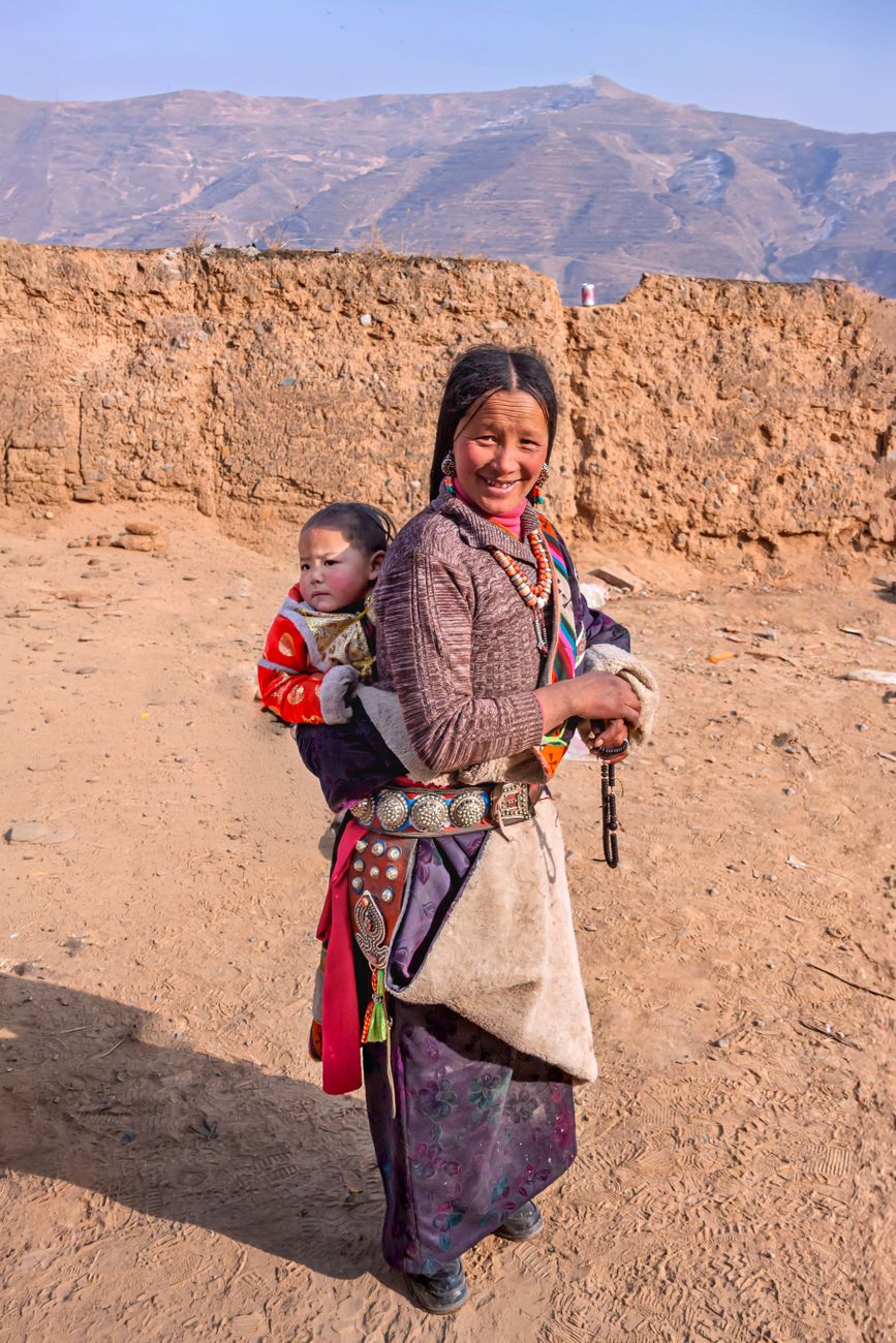 Tibetan woman carrying a child